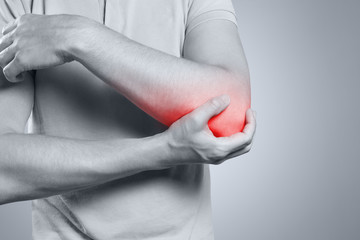 Man feeling pain in his elbow