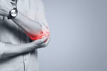 Man feeling pain in his elbow