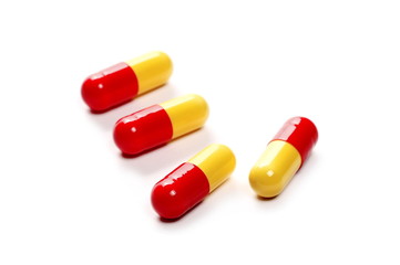 red yellow pills, medicine isolated on white background, top view