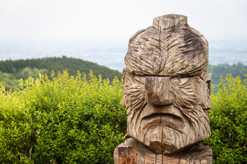 wood carved face with big nose