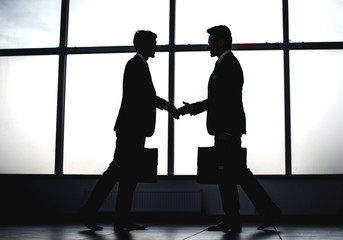 two business people holding out their hands for a handshake