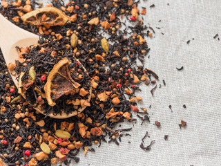 Dry leaves of black fruit tea with cinnamon, apple, orange, coriander, cardamom, cloves and red pepper