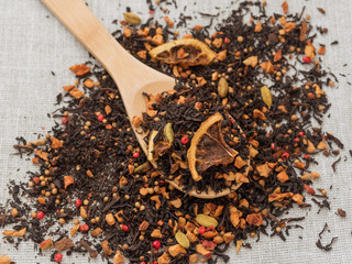 Dry leaves of black fruit tea with cinnamon, apple, orange, coriander, cardamom, cloves and red...