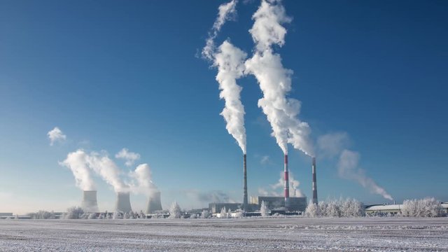 Time lapse of the smoking pipes of the  thermal power station in winter
