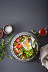 quinoa bowl with fried egg, avocado, tomato, rocket. Healthy vegetarian lunch