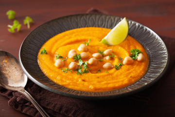 creamy carrot chickpea soup on dark rustic background