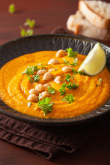 creamy carrot chickpea soup on dark rustic background