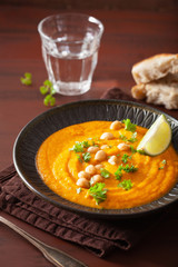 creamy carrot chickpea soup on dark rustic background