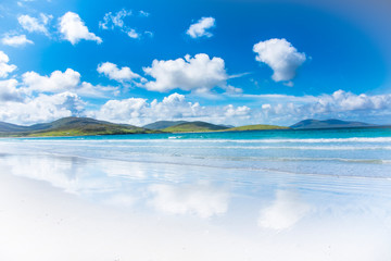Exotic paradise island landscape with turquoise sea, mountains, beautiful sandy beach and blue sky - Isle of Harris in Scotland