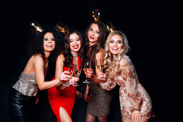 Four young beautiful women together celebrating party