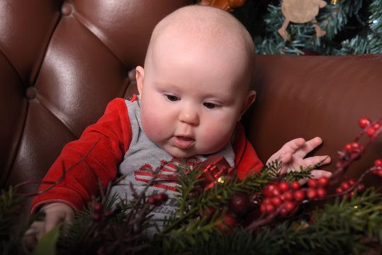 Newborn Baby In Red And Gray Jumpsuit