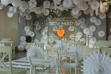 Wooden arch and chairs at wedding ceremony with words all you need is love