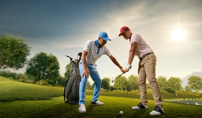 Poster Male golf players on professional golf course. Golfer teaches to play golf © Alex