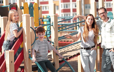 young family with children having fun on the Playground