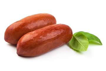 Pork Smoked Sausages with basil, close-up, isolated on a white background