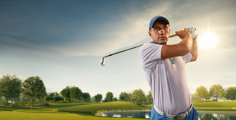 Male golf player on professional golf course. Golfer with golf club taking a shot