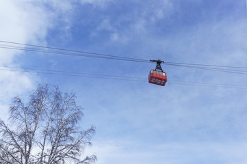 Old red cable car on a background of blue sky