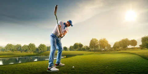 Poster Male golf player on professional golf course. Golfer with golf club taking a shot © Alex