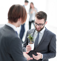 successful young businessman with young sprout