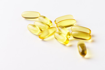 Fish oil capsules with omega 3 on white background. Copy space.