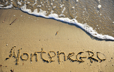 Montenegro travel sign on the beach