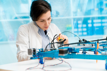 Young woman in CNC and robotics laboratory