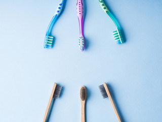 Plastic toothbrushes versus bamboo. Concept