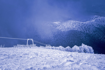 Landscape of snow mountains, lift and fence in 3-5 Pigadia, Naoussa, Greece.