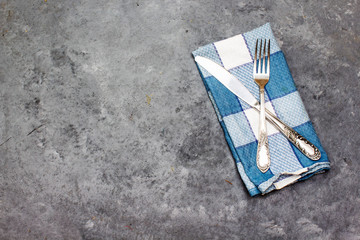 knife and fork above napkin, lunch concept