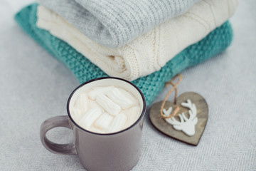 coffee with marshmallows and cozy knittaed sweaters
