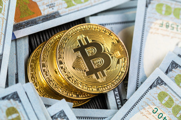 golden bitcoin coin on us dollars close up. Electronic crypto currency