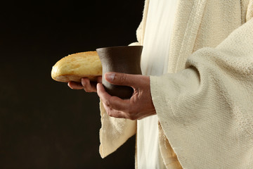 Jesus hands holding the wine and bread