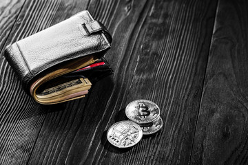 Silver and golden coins with bitcoin, ripple and ethereum symbol on wood background.