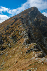 rocky Tatra mountain tourist hiking trails under blue sky in Slovakia