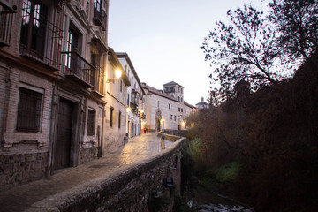 Fototapeta na wymiar Dawn twilight in Granada, Spain. Carrera del Darro street, Darro river.