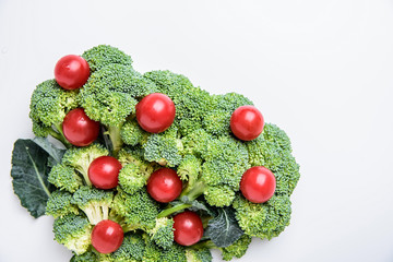 Broccoli dish and small tomatoes/supermarket fresh creative poster material on white background