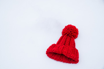 red hat with bubo on white snow. overhead view. flat lay