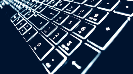 Closeup of laptop keyboard illumination, backlit keyboard