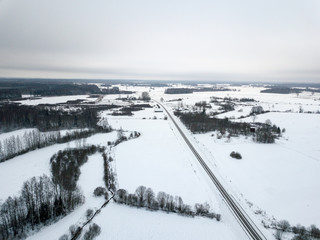 Fototapeta na wymiar country roads in winter and small village from above