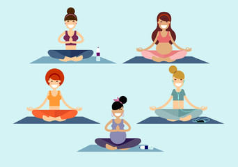 A group of yoga girls and young ladies meditates sitting on a pilates mat in a Sukhasana easy pose