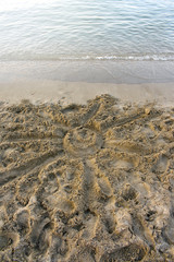 A sun formed on the sand of a beach