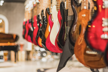 guitars, showcase with guitars hanging in a row