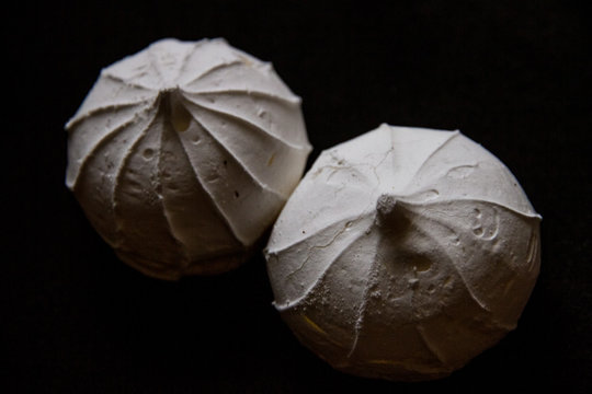 White meringue cake, marshmallow on a black background