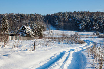 Obraz premium Russian winter landscape with snowy forest and winter road in a lot amount of snow in Russia at 06.01.2019