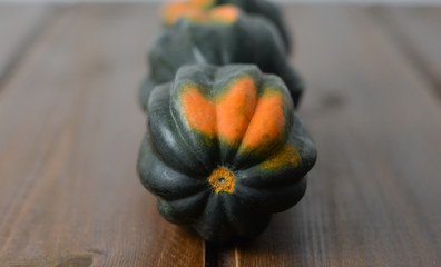 Green Acorn squash on wooden table  