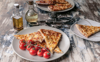 Pizza Four cheese and cherry tomatoes on a plate. Traditional Mediterranean cuisine