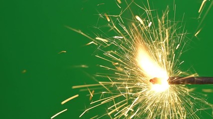 Burning bengal light in real time. Fire sparkler moving on green screen background. 4K video footage