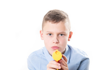 Young with a confetti pistol looking into the camera on white background - he wears a blue shirt