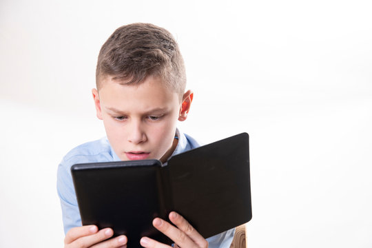 young child reading strained in an e book reader on white background