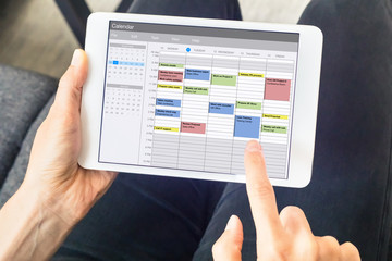 Calendar app on tablet computer with planning of the week with appointments, events, tasks, and...